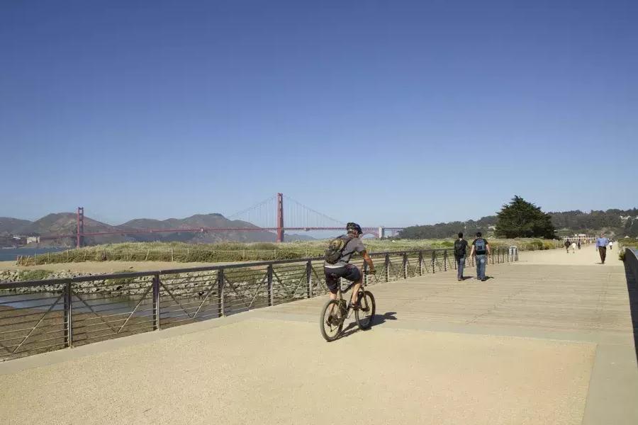 一名男子在克里西球场的小路上骑自行车. San Francisco, California.